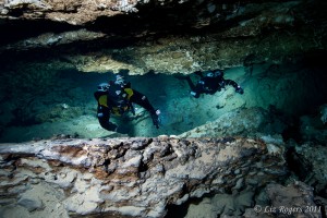 Photo-6 Divers move through Tank Cave, Australia. Only the rocks at the top and bottom of the shot are being lit by the camera – the rest of the lighting is from the off camera strobes carried by the divers.